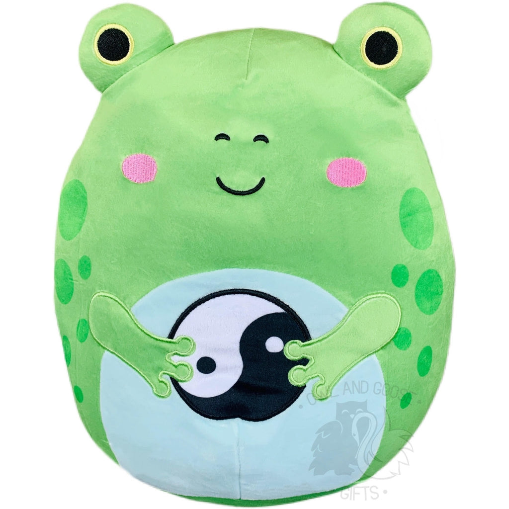 A green frog-shaped plush toy with a smiling face, white and black eyes, and a marshmallow-like texture.
