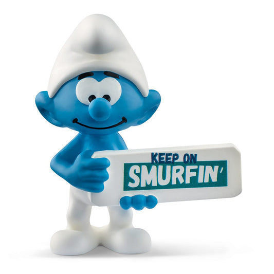 A figurine of a blue Smurf holding a sign with the phrase 'KEEP ON SMURFIN' written on it.