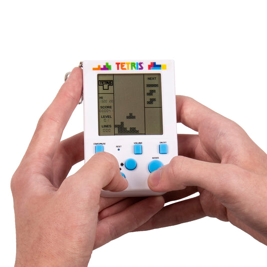 Handheld Tetris Keyring Arcade Game being held in a person's hands with a visible screen and buttons.