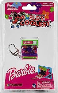 A miniature Barbie Polaroid camera toy with a pink and purple color scheme, packaged in a blister pack.