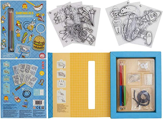 A collection of shrink art activity sets including colored pencils, key rings, and illustrated sheets displayed in an open box.