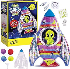 Glow in the Dark Sand Art Rocket Ship-Toys-Renee Levine Sales-SPACE SAND ART: Explore an intergalactic world with a rocket ship of sand art! Create your own outer space toy full of neon and glow-in-the-dark sand, foil accents, and assorted stickers. This arts and crafts kit provides the perfect experience for rainy days, kids gifts, birthdays, and more! OUTER SPACE GIFTS: A creative space gift for girls and boys ages 6-8+! This sand art kit is out of this world and kids will love to layer, decorate and play