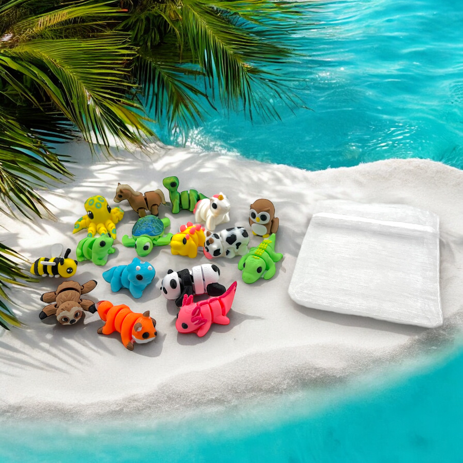 Colorful animal toys on a white towel by a pool with palm leaves.