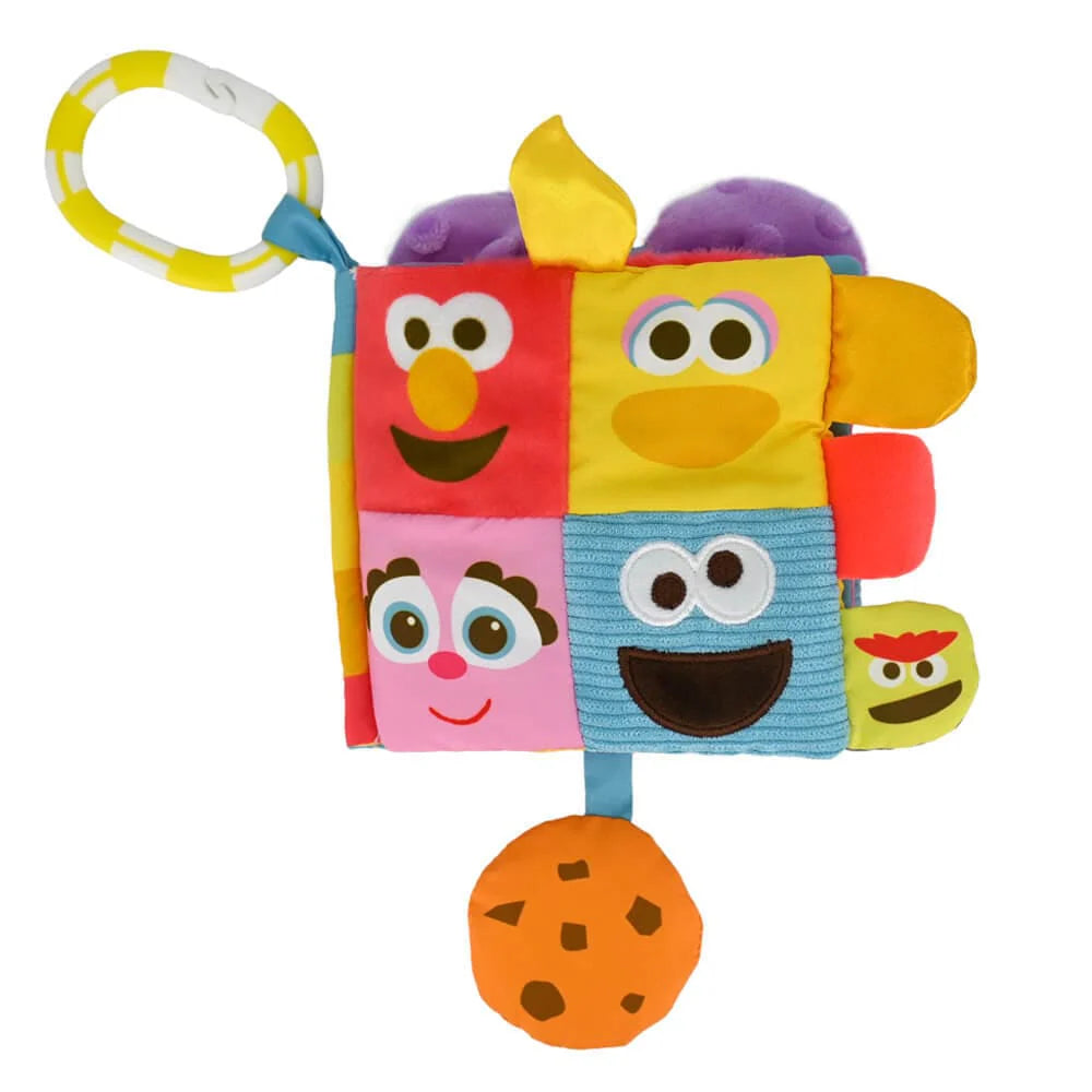 A colorful Sesame Street soft book with various characters' faces on each page, designed for babies.