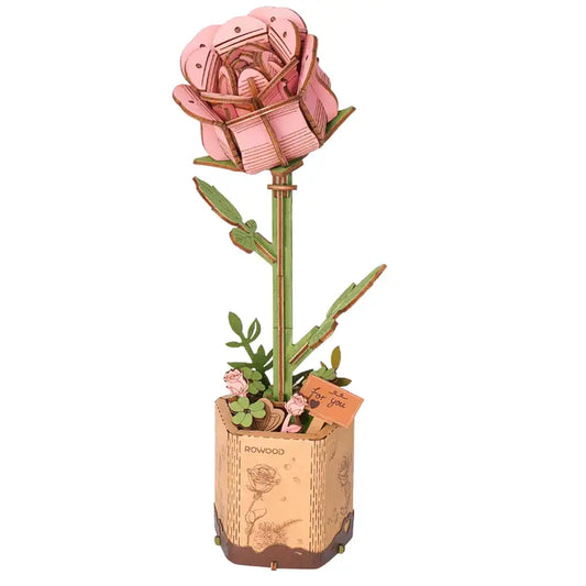 A 3D wooden puzzle model of a pink rose with a kraft flower pot.