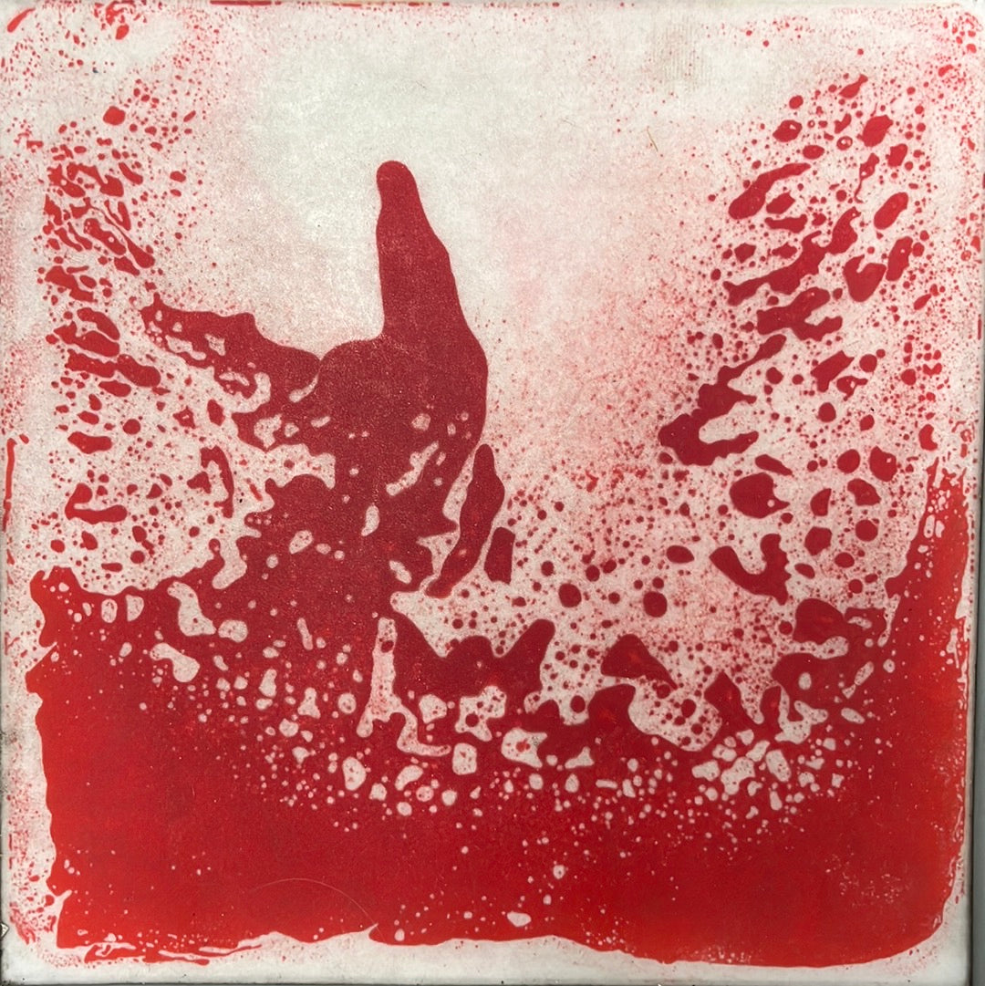 A red and white liquid tile mat with a splattered paint appearance.
