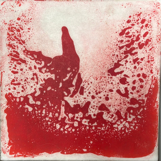 A red and white liquid tile mat with a splattered paint appearance.