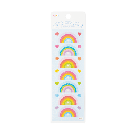 A sheet of holographic stickers with various rainbow designs and heart shapes.