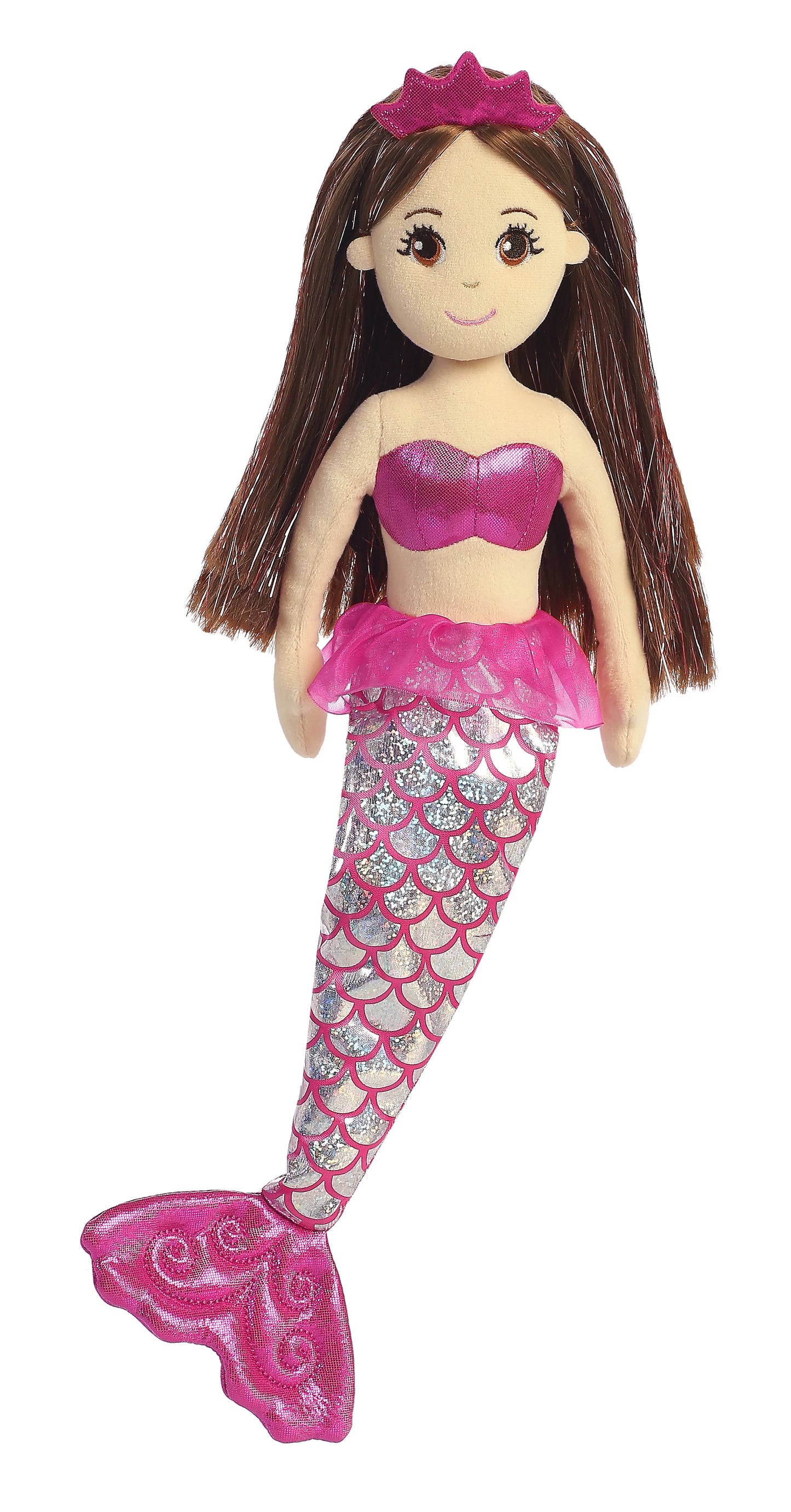 A plush doll of a mermaid with brown hair and pink, sparkly highlights. The mermaid doll has brown eyes, long eyelashes, and is wearing a sparkling silver and pink tail, matching pink tutu outfit, and a bright pink crown.
