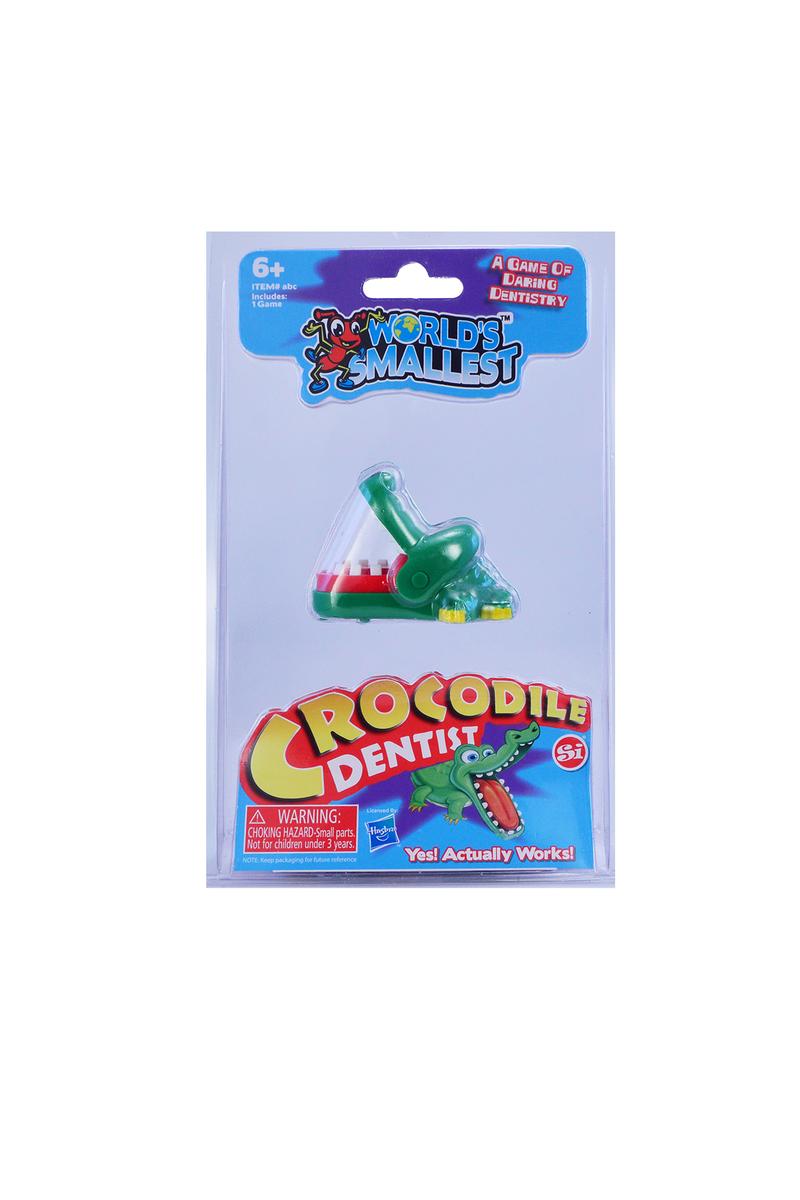 The product is a small toy crocodile in green color, packaged in a blue blister pack with product information.