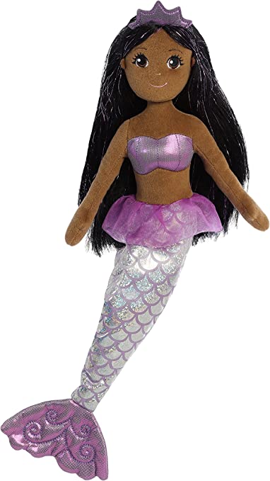 A plush doll resembling a mermaid with a purple and silver outfit, featuring unique shimmer fabrics and sparkly doll hair.