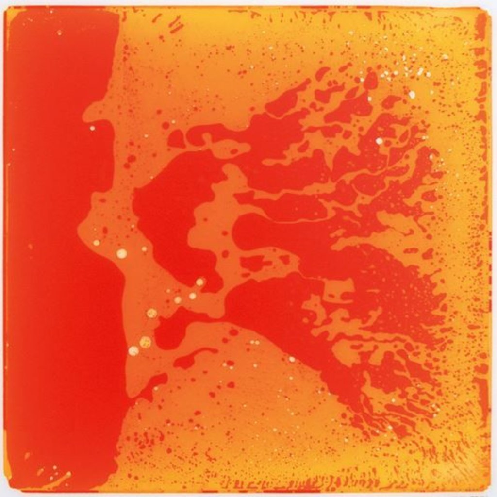 An orange liquid tile with a pattern resembling splattered paint or a abstract design.
