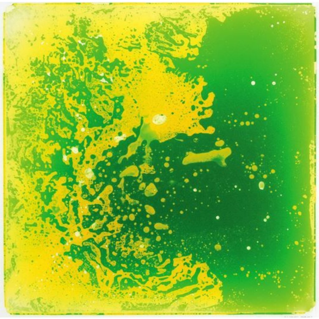 A green and yellow liquid tile with a pattern of splashes and bubbles, designed for children's play.